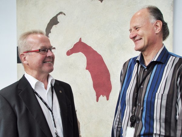 Insta Group’s Chief Executive Officer Pertti Huusko and Insta Innovation’s Vice President Esa Einola in the lobby of the new building. Art work on the walls by Osmo Rauhala.​